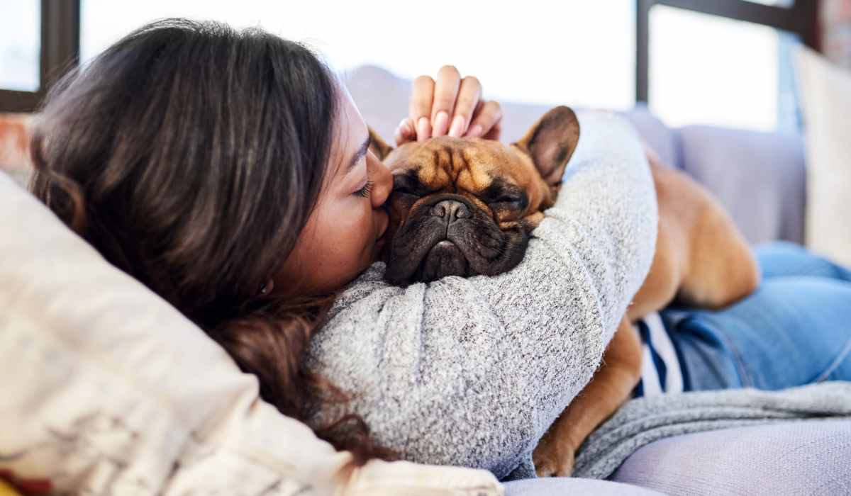 Woman snuggling with dog