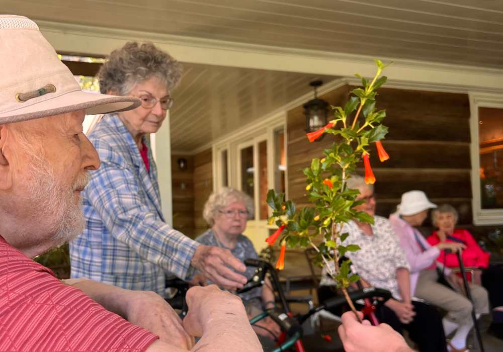 Resident receiving flowers at Merrill Gardens at The University in Seattle, Washington