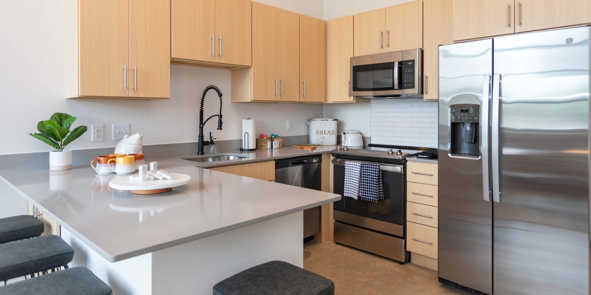 Kitchen with stainless-steel appliances at Mojud Lofts in Greensboro, North Carolina