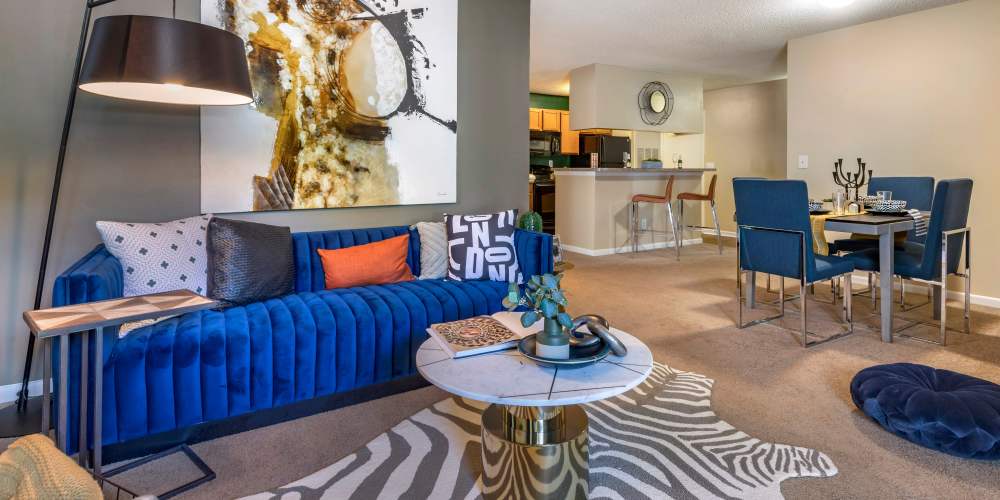 A furnished apartment living room and seating at a kitchen island at Avenue at Harbison in Columbia, South Carolina 