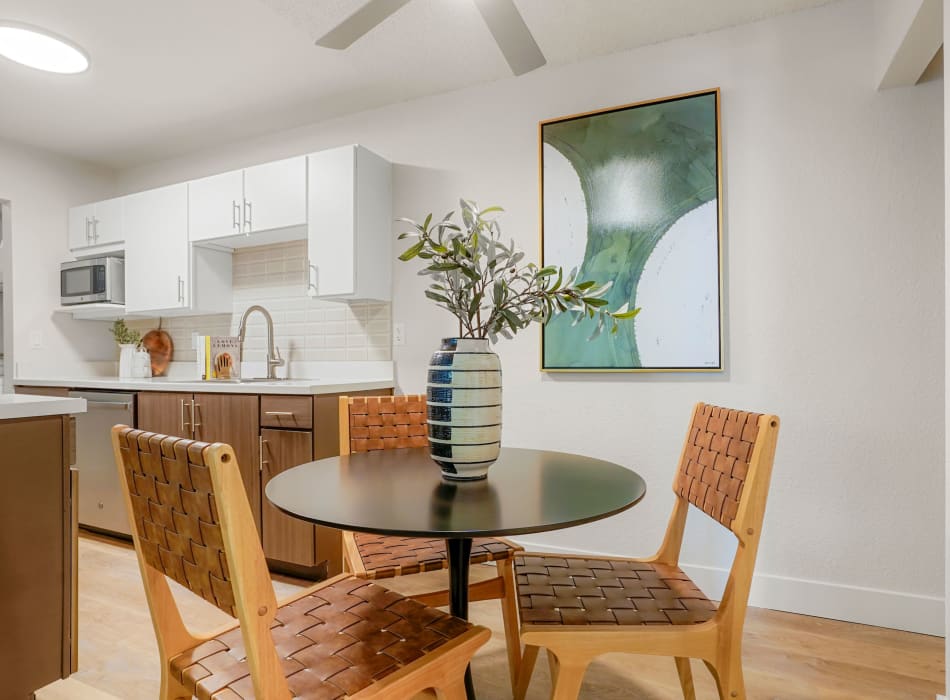 Cozy dining area with seats for four in a model home at Sofi Belmar in Lakewood, Colorado