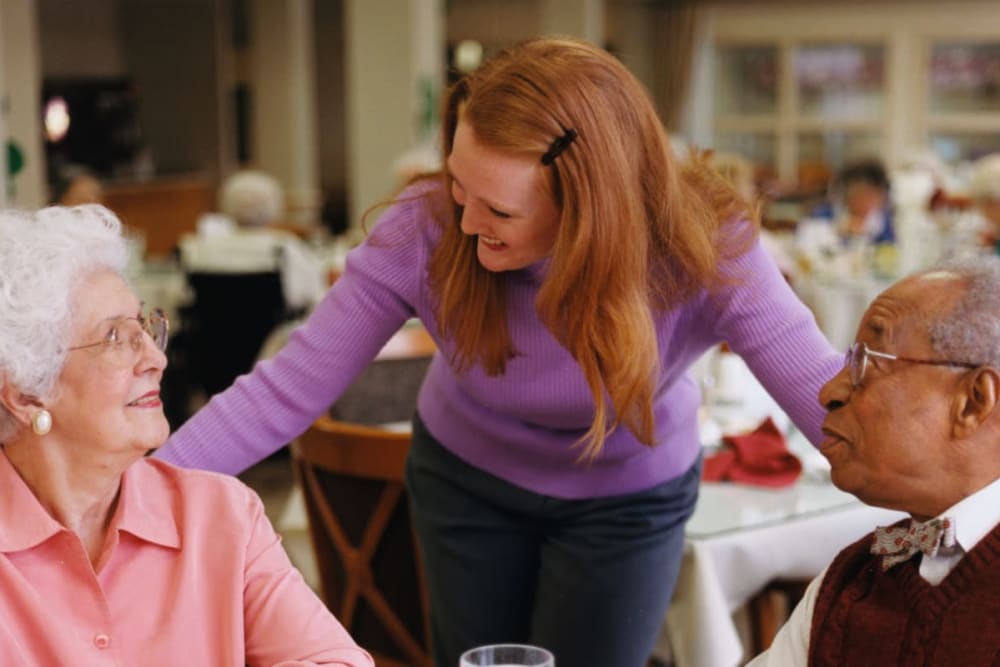 Residents with staff in dining room at The Atrium in Rockford, Illinois