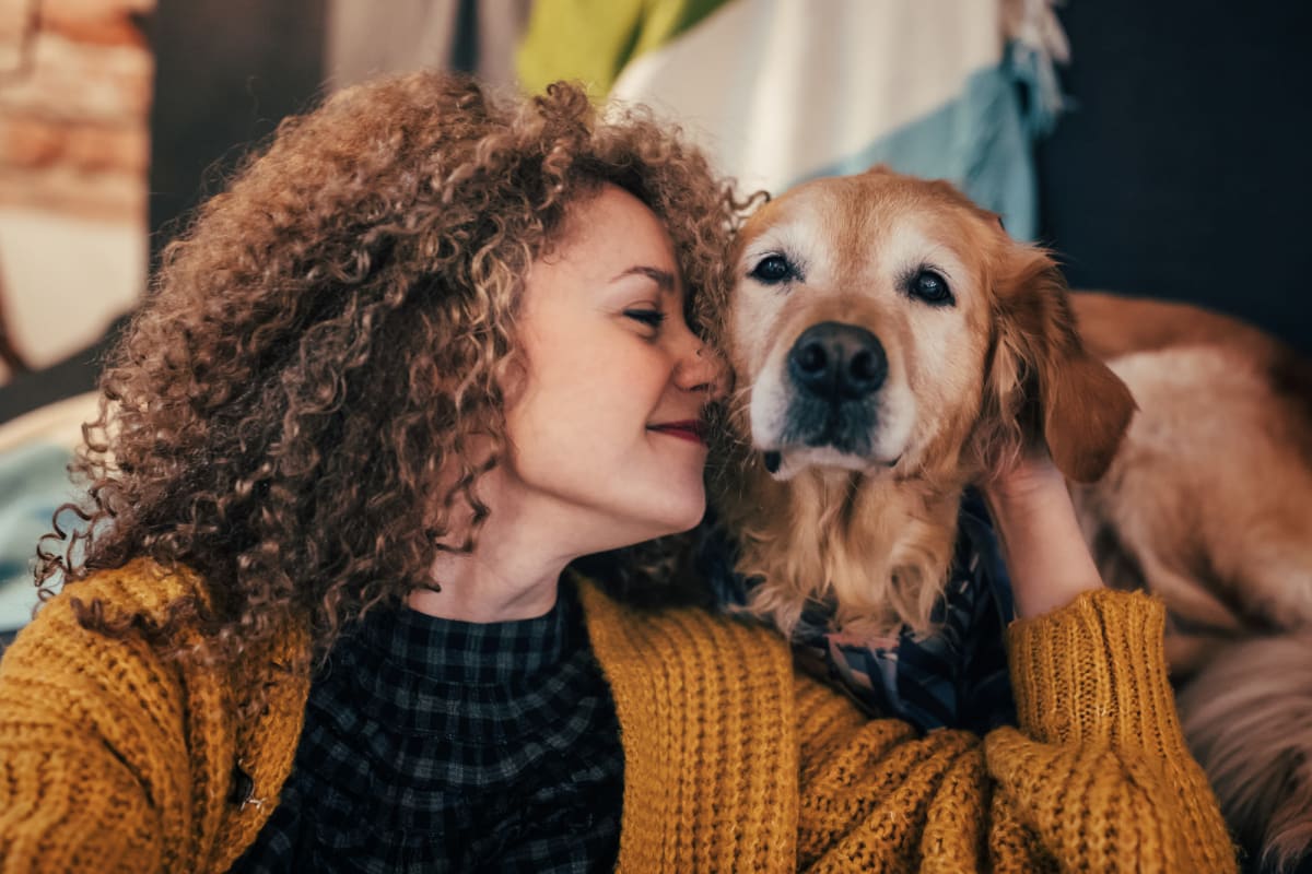 A woman with her older golden retriever at Integra Heights in Clermont, Florida