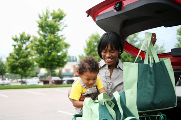 A mother and child loading groceries into their trunk near Forest Edge Townhomes in Raleigh, North Carolina