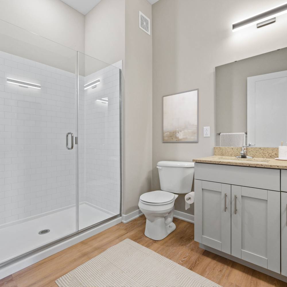 Bathroom with walk-in shower and wooden flooring at Neo Vantage Point in Maryland Heights, Missouri