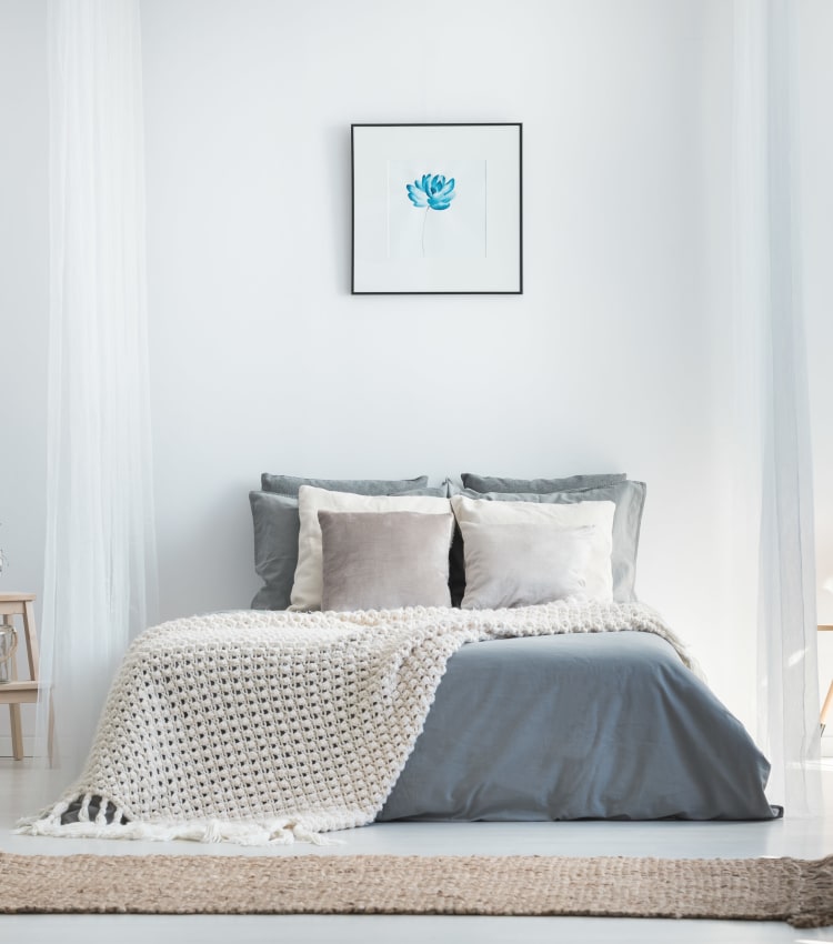 Minimalist decor in a model home's bedroom at Sofi at Morristown Station in Morristown, New Jersey