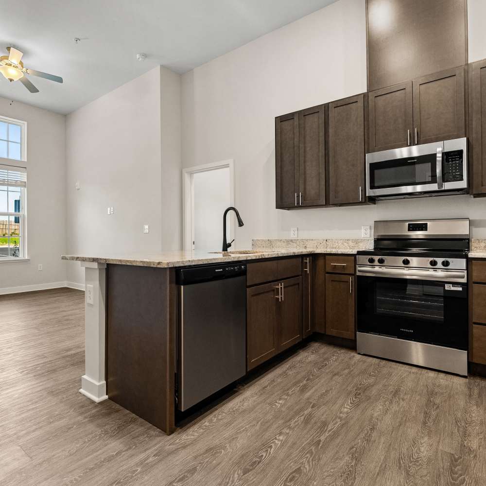 Kitchen with view to unfurnished living room at Helios in Richmond, Virginia