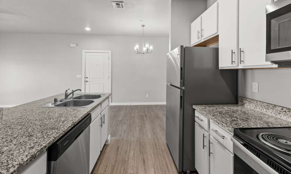 Kitchen with refrigerator and dishwasher at Retreat at Horizon Hills in El Paso, Texas