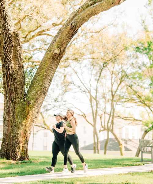 Two women running at a nature park that resembles Flowood Nature Park near The Heights at Waterpointe in Flowood, MS