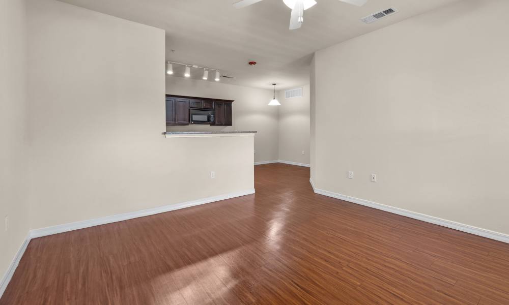 Living room with wooden flooring at Las Torres Apartments in El Paso, Texas