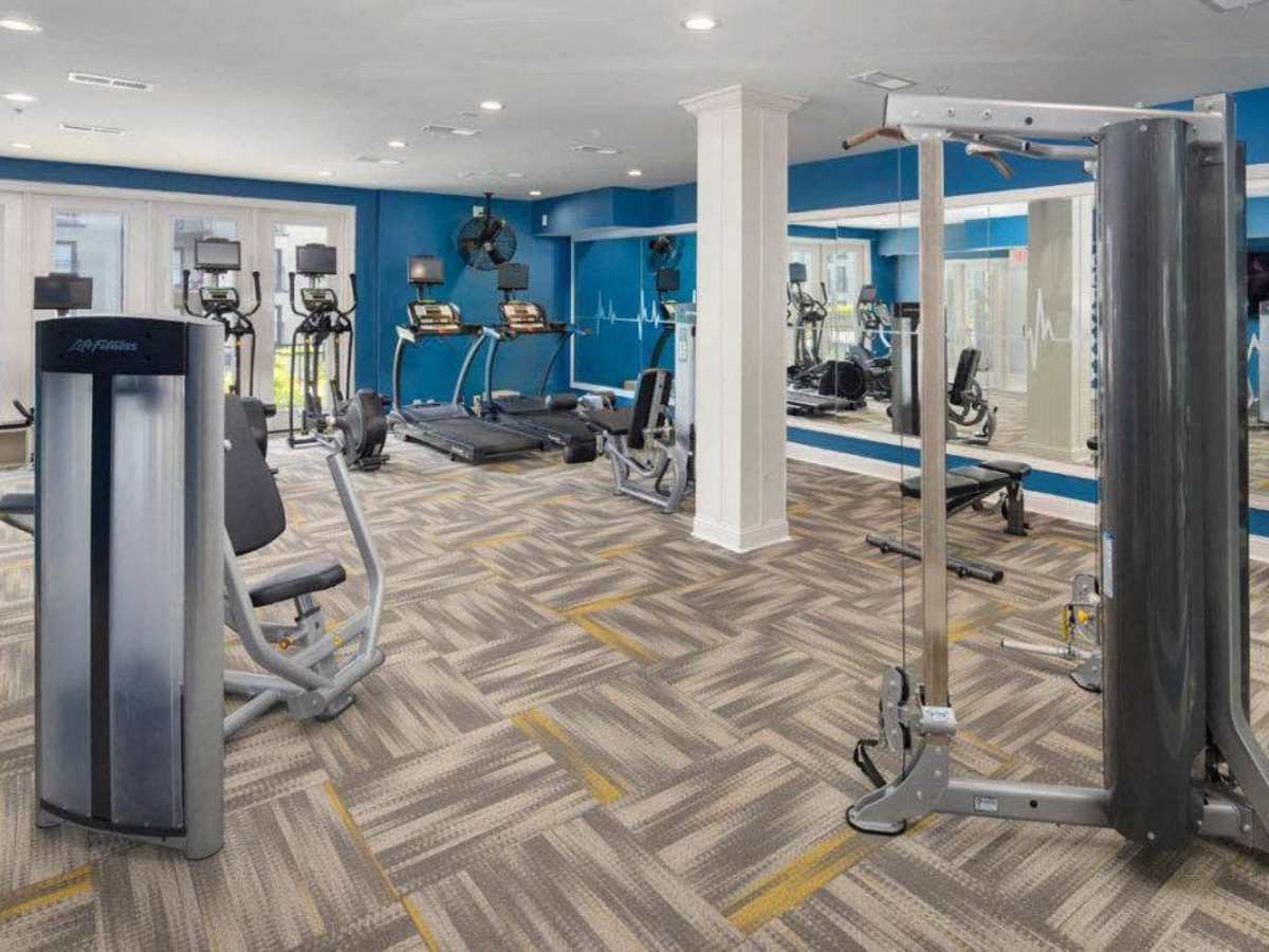 Gated gym equipment with cardio machines and weights at Ardmore & Twenty Eighth in Atlanta, Georgia