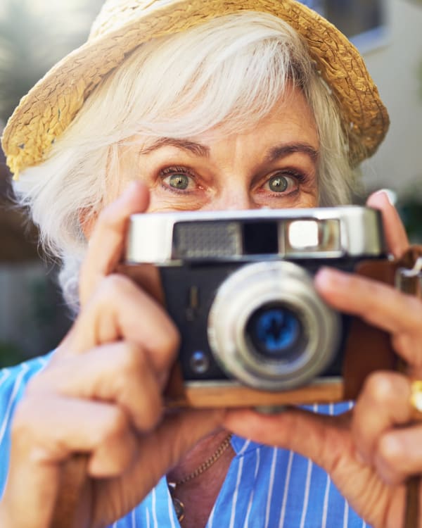 A woman taking a photo at Trilogy Health Services in Louisville, Kentucky