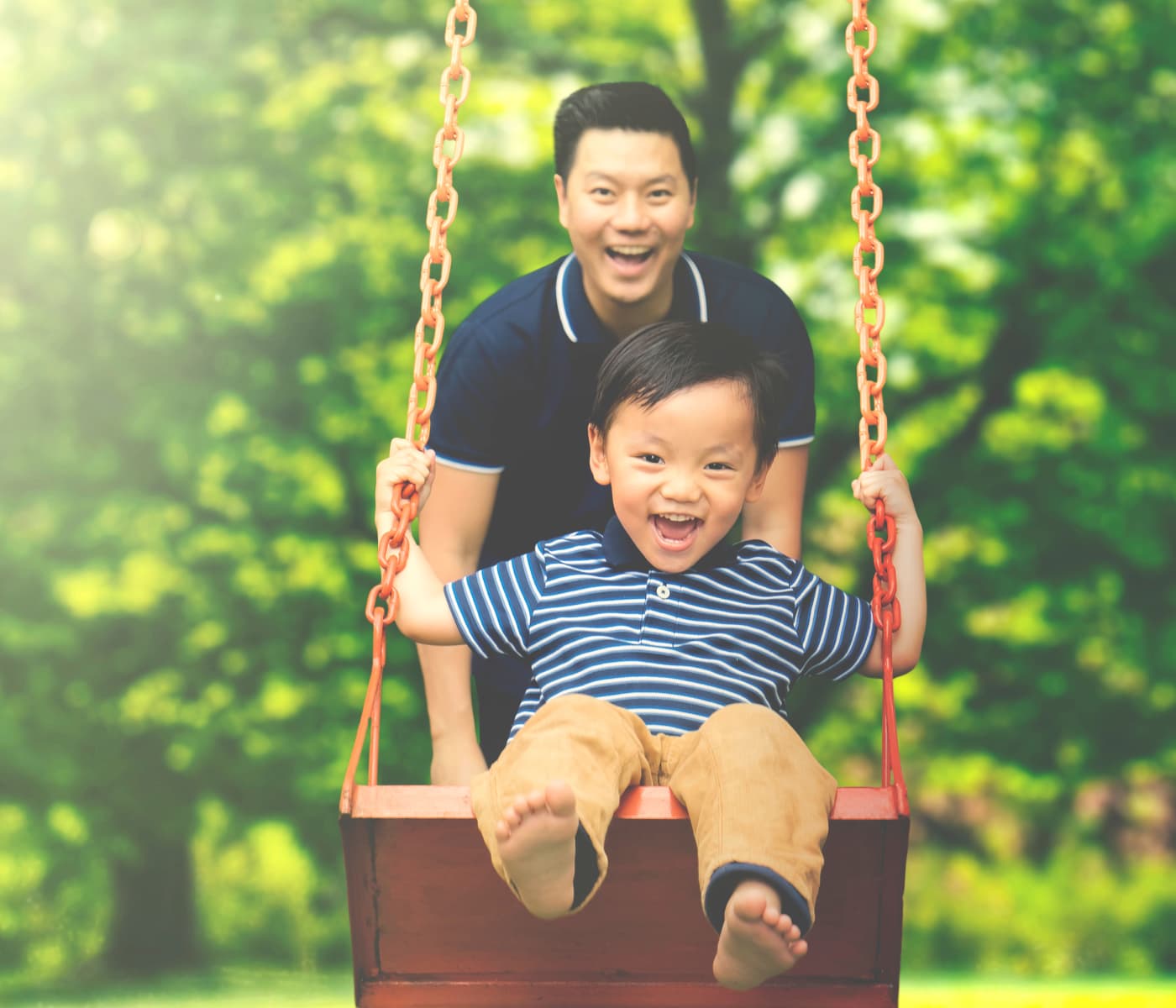 Father pushing his son on the swing in Derwood, Maryland near Shady Grove Apartments