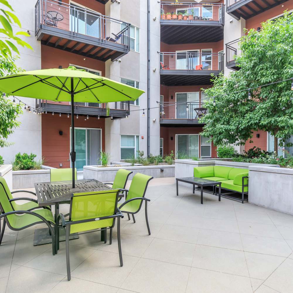 Outdoor seating area with chairs, tables and couch at Park Place Olde Town Apartments in Arvada, Colorado