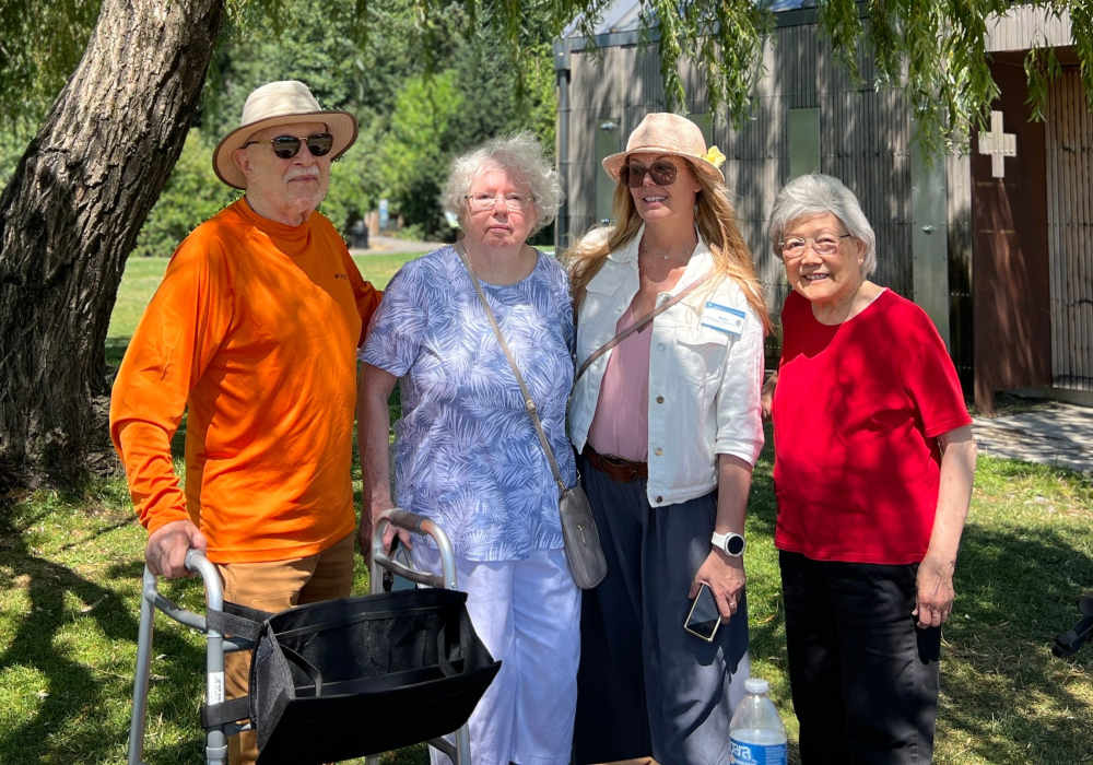 Residents posing next to a tree near Merrill Gardens at The University in Seattle, Washington