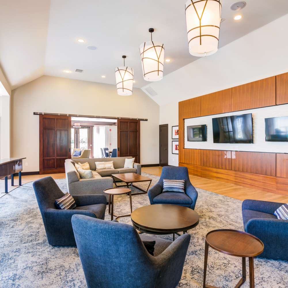 Community lounge seating area with hanging lights at Grove at Somerset in Somerset, New Jersey