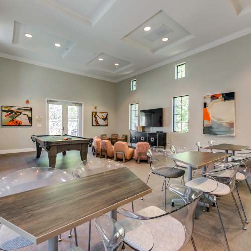 Resident clubhouse with billiards table, TV and seating area at Links at Westridge in Valencia, California