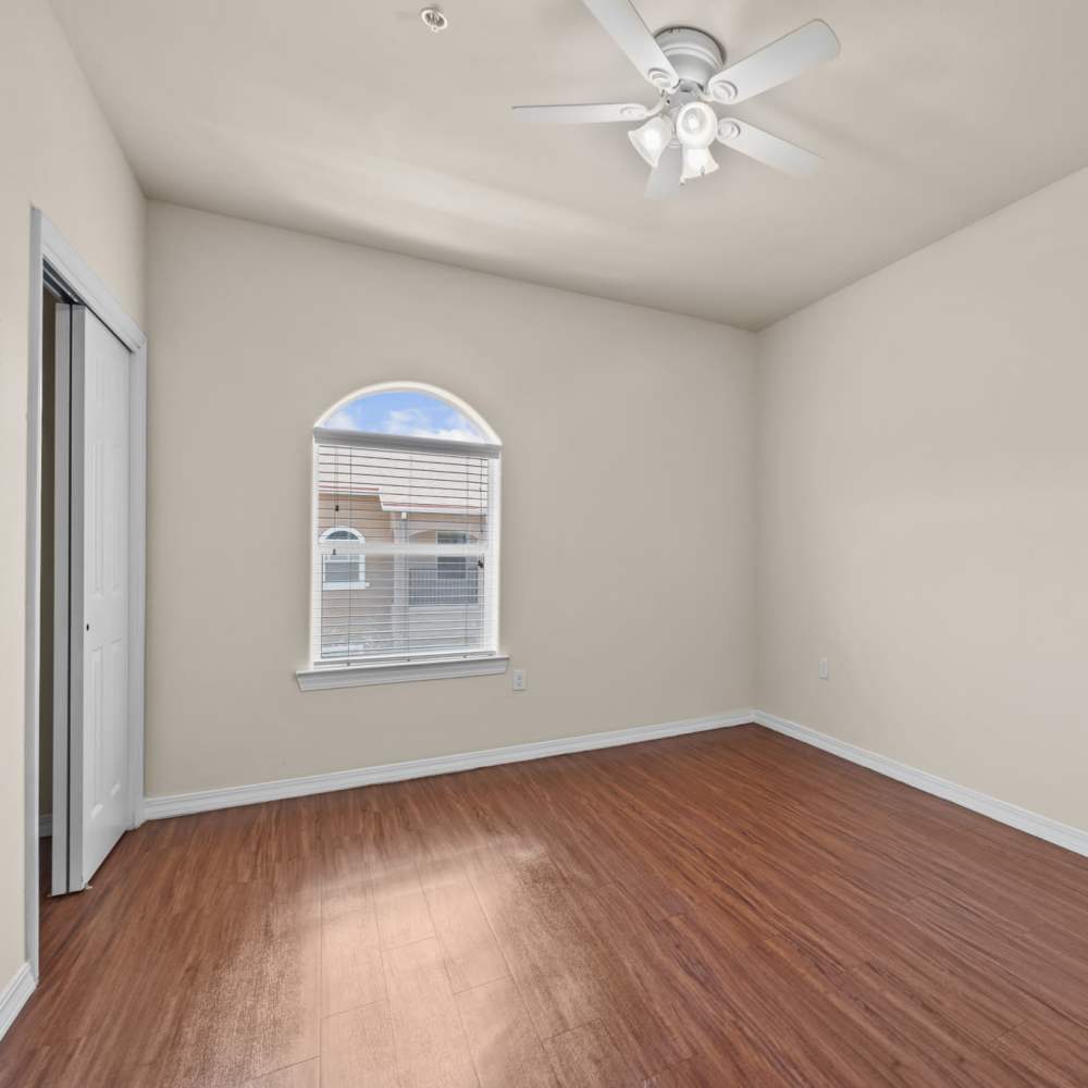 Spacious bedroom with ceiling fan at Las Torres Apartments in El Paso, Texas