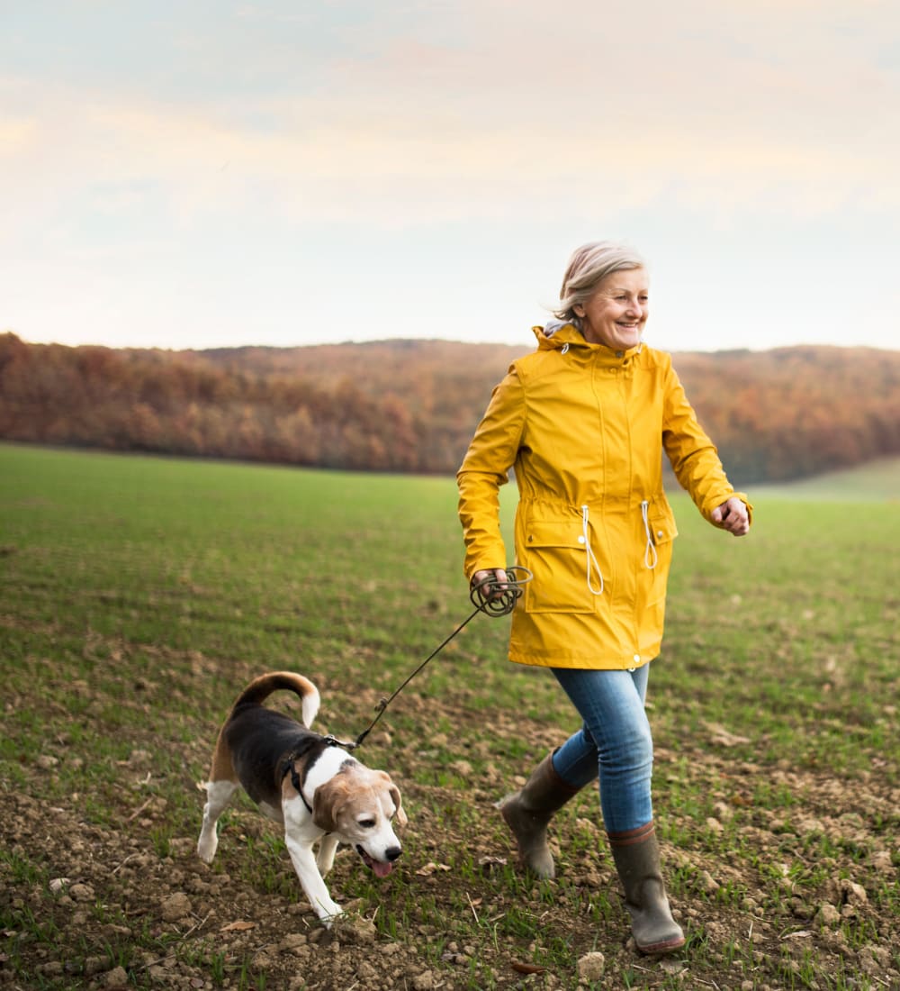 Resident out for a walk with her dog near Savanna House in Gilbert, Arizona