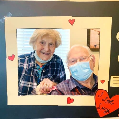 Resident couple posing in a picture frame at The Oxford Grand Assisted Living & Memory Care in McKinney, Texas