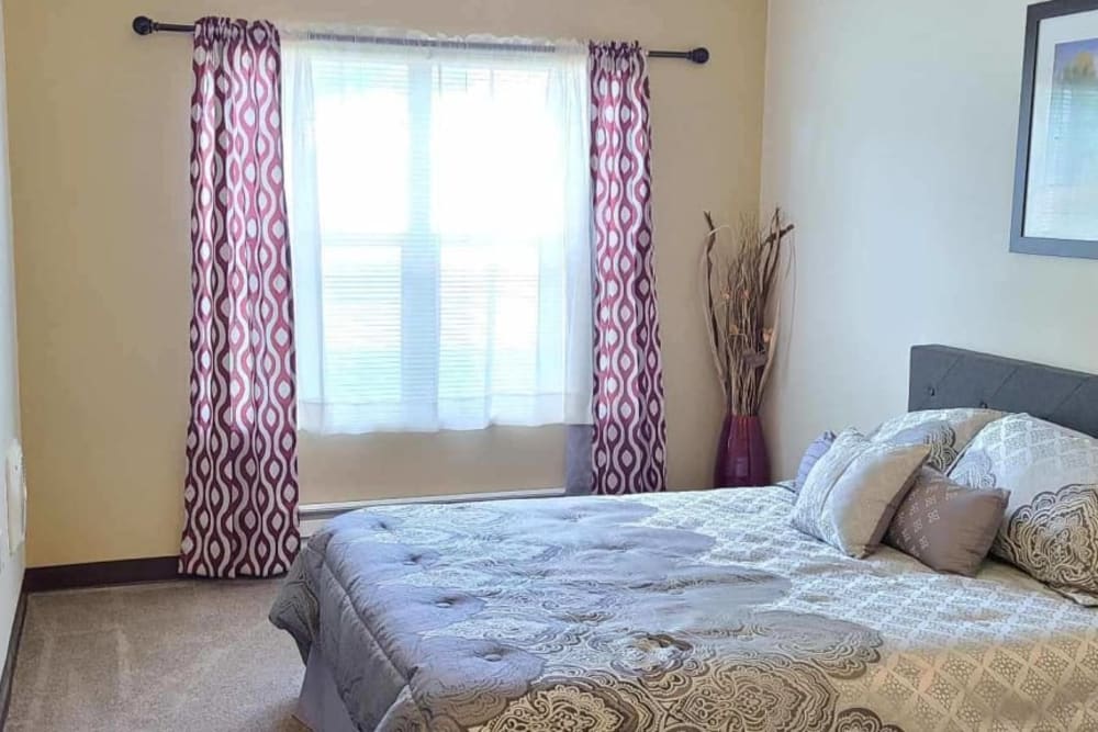 Serene bedroom in apartment at Lakeland Senior Living in Eagle Point, Oregon.