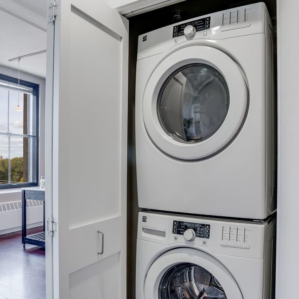 Laundry room with stackable washer and dryer at 430 Oak Grove in Minneapolis, Minnesota