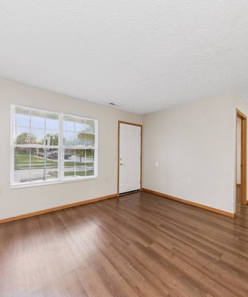 Living room with wood flooring at Webster Glen in Peebles, Ohio