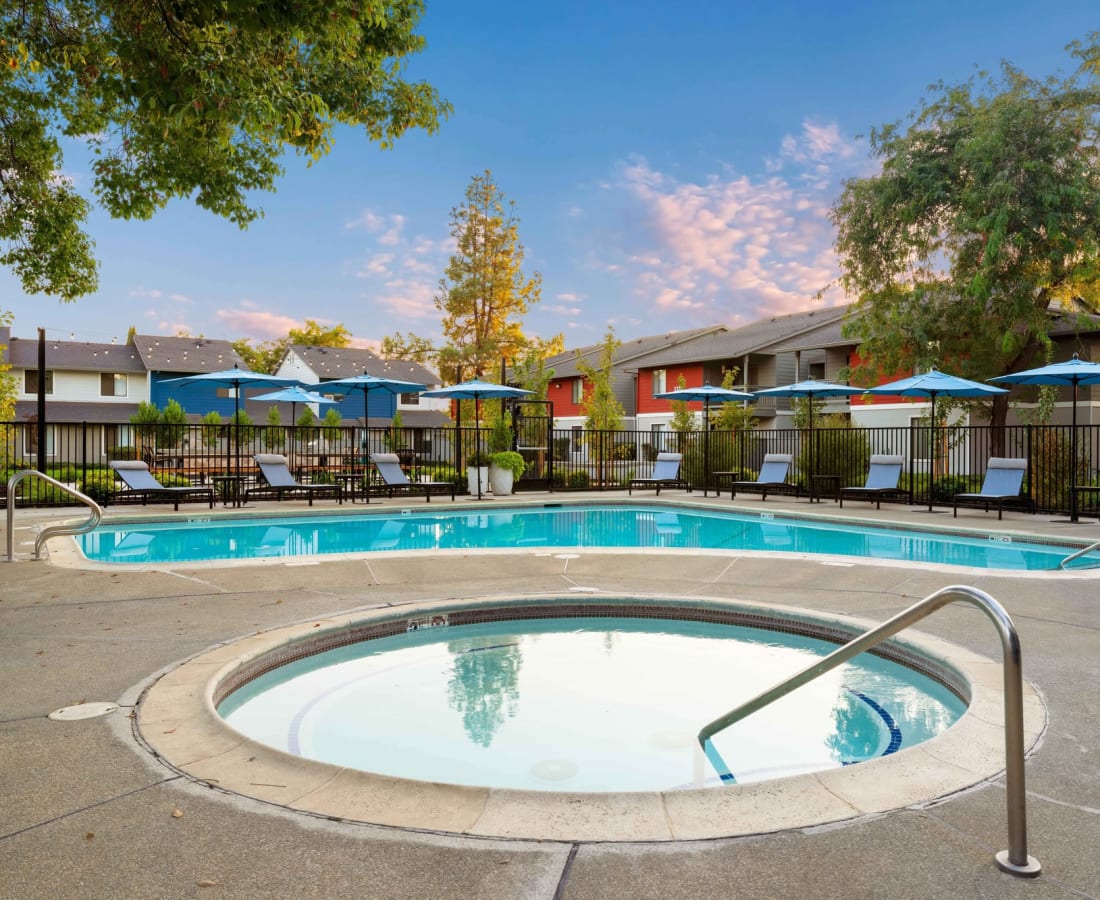 2-BR Apartments in Dixon, CA - The Mews at Dixon Farms - Gated Pool Area with Spa, Lounge Chairs, and Umbrellas at The Mews At Dixon Farms in Dixon, California