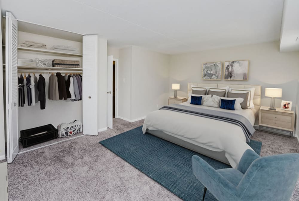 Model bedroom with plush carpeting and a large closet at Marchwood Apartment Homes in Exton, Pennsylvania