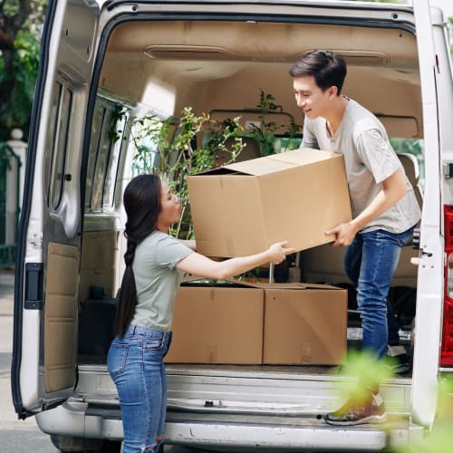 A couple loading a van with boxes to be stored at Red Dot Storage in Jackson, Mississippi