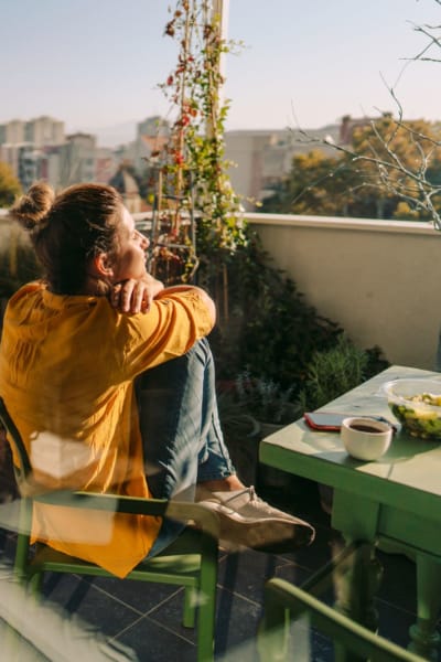 A resident enjoys her private patio at Amanda Regency Apartments, Van Nuys, California
