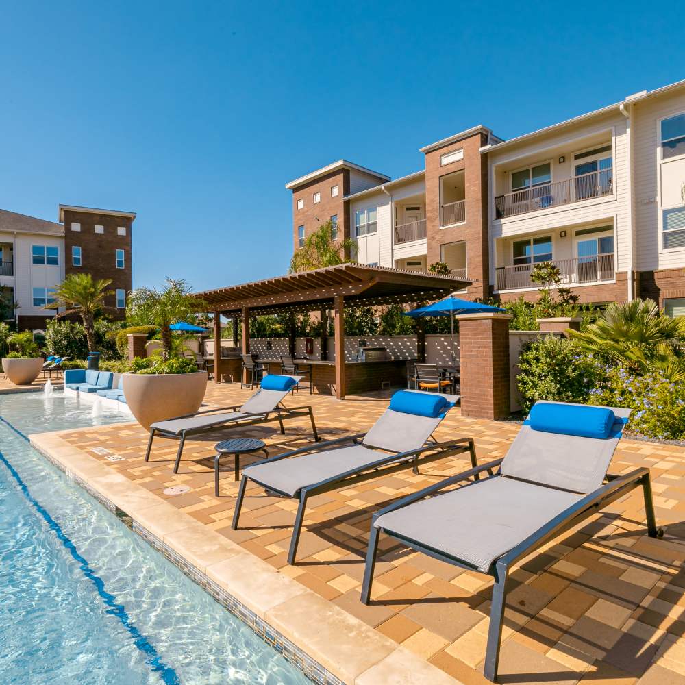 Swimming pool with lounge chairs at NOVU New Forest in Houston, Texas