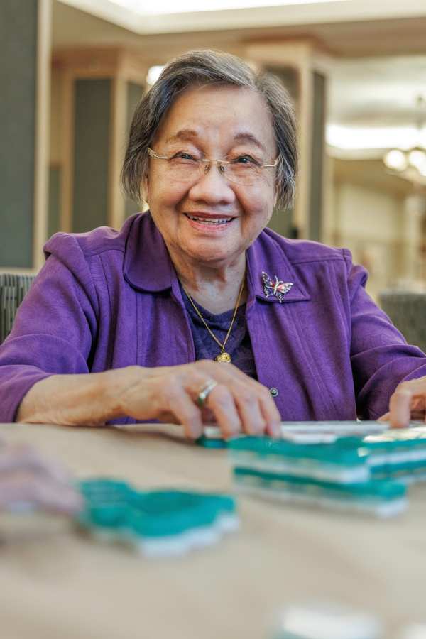 Resident smiling and playing a game