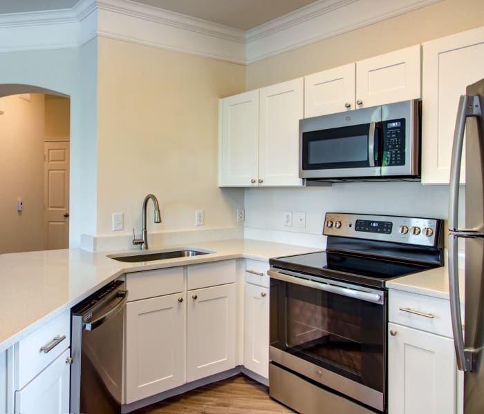 Modern kitchen with stainless-steel appliances in model home at Amberjack Estates in Houston, TX