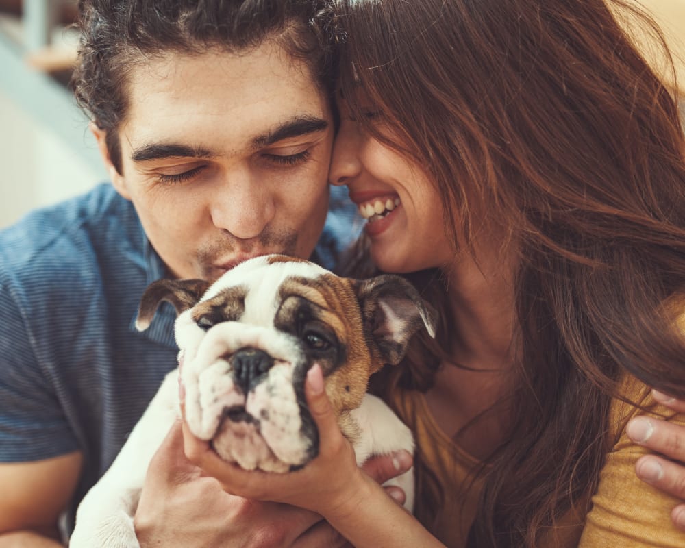 Residents hugging their dog at Olympus at Memorial in Houston, Texas