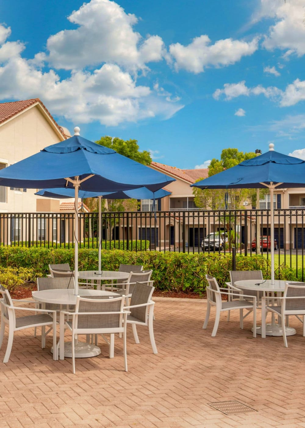 Patio with tables and chairs at The Estates at Wellington Green Apartments, Wellington, Florida
