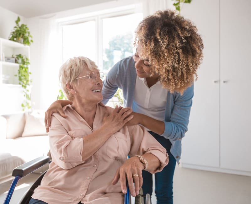 A caretaker and resident embrace at The Sanctuary at St. Cloud in St Cloud, Minnesota