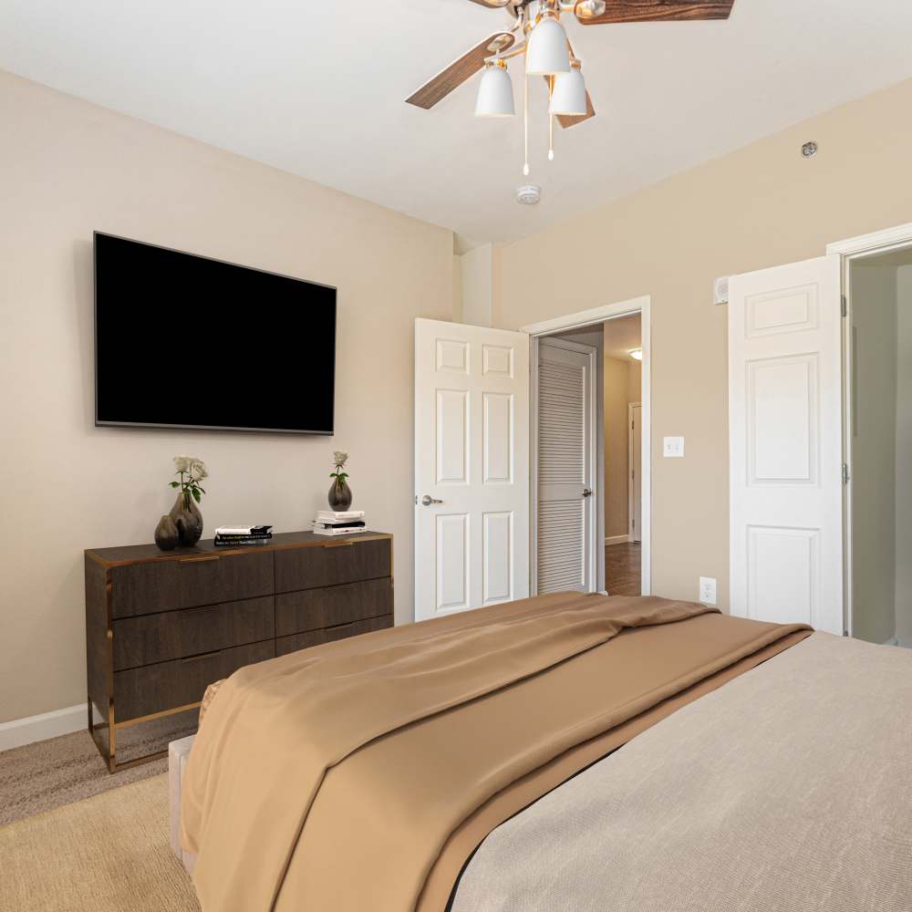 Bedroom with carpet flooring and television at Boulder Springs of Columbia in Columbia, Missouri