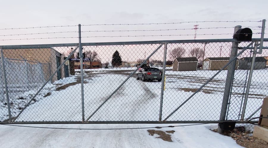 Secure gate topped with barbed wire at KO Storage in Willmar, Minnesota
