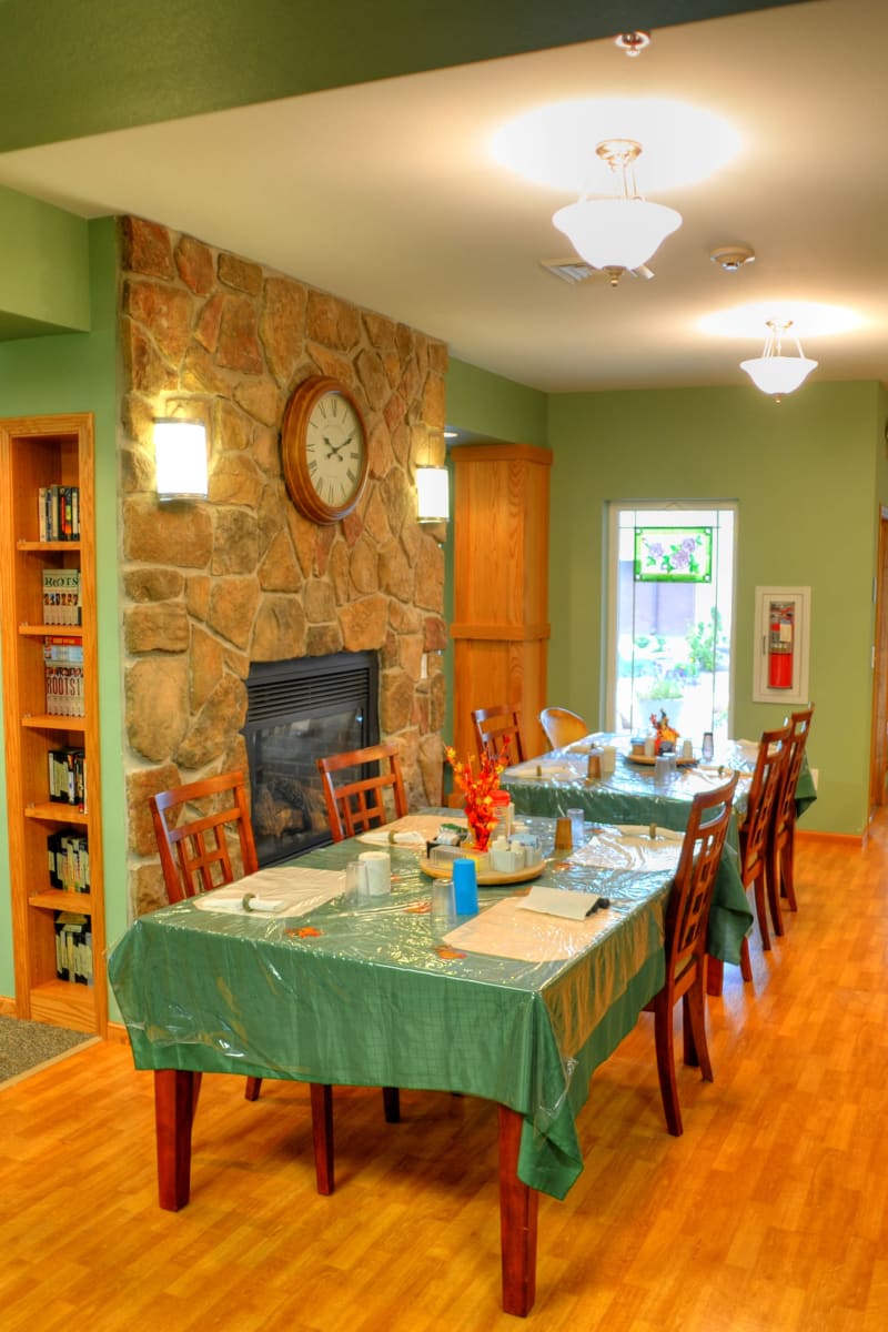 Dining tables and fireplace at The Residences on Forest Lane in Montello, Wisconsin