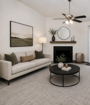 Furnished living room with wood burning fireplace at Cloisters of Mount Holly in Mount Holly, North Carolina