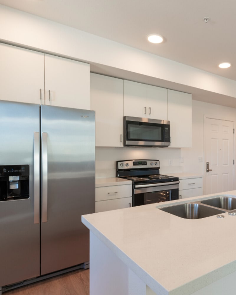 Kitchen with stainless-steel appliances and white cabinetry at Eight Mile House in Stockton, California