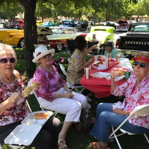 Residents eating outside at a community event at Quail Park on Cypress in Visalia, California