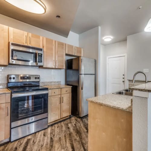 Apartment kitchen with an island at Square9 in Denton, Texas