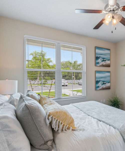 Beautiful bedroom with ceiling fan at The Bergamot Apartments On 780 in Sarasota, Florida