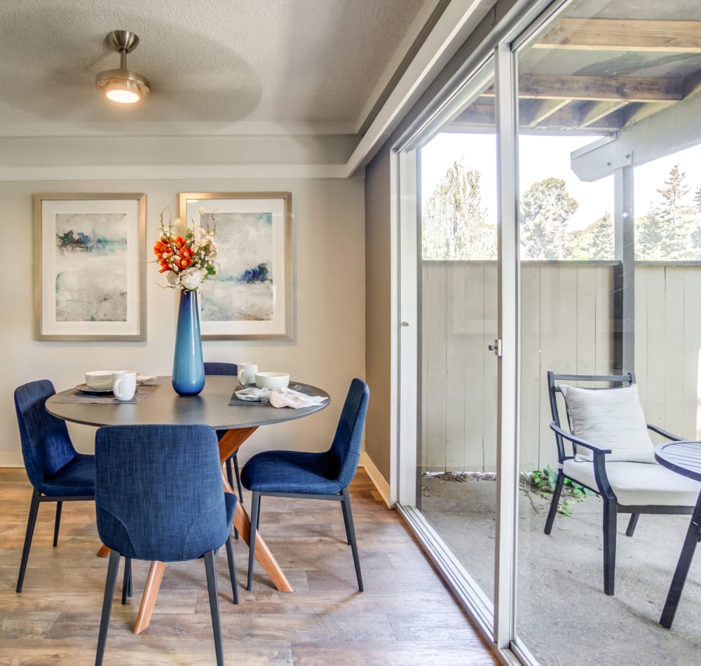 Dining area with a ceiling fan next to a model home's private patio at Sofi Fremont in Fremont, California