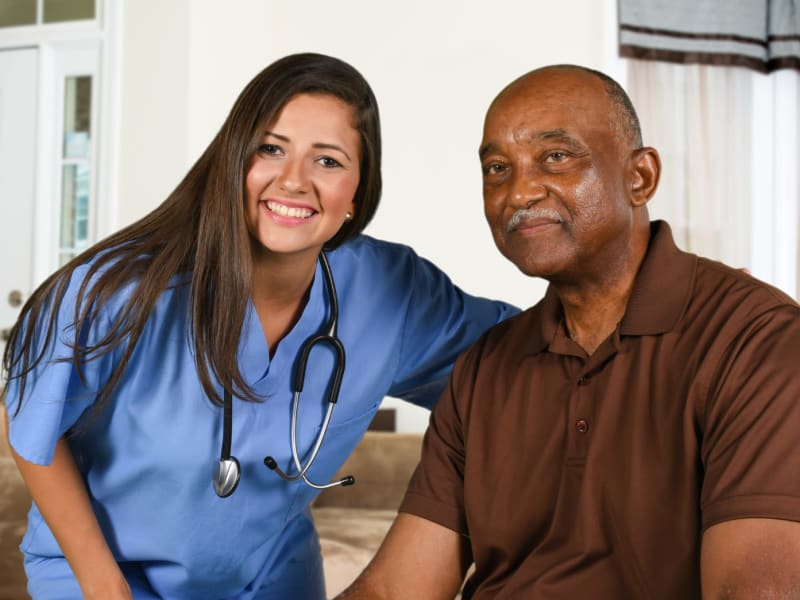 Resident and nurse smiling for the camera at Holton Manor in Elkhorn, Wisconsin