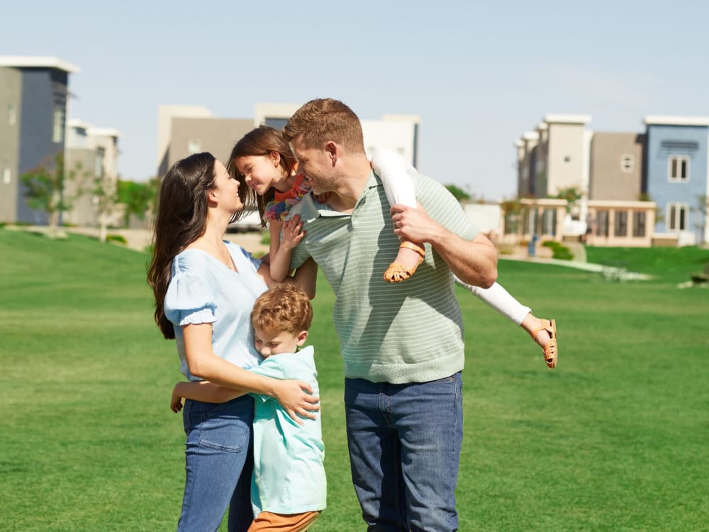 Residents playing on the grass area at BB Living Union Park in Phoenix, Arizona