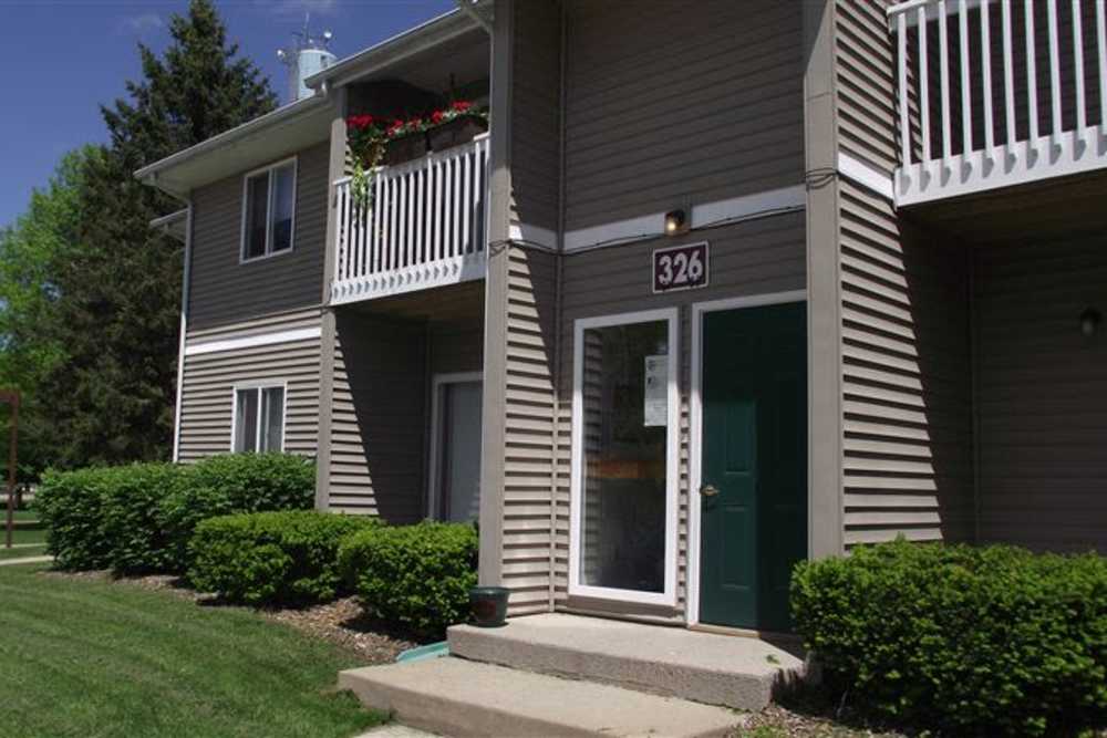 Exterior view of the apartment building with a private balcony at Mapleview Apartments in Maple Rapids, Michigan