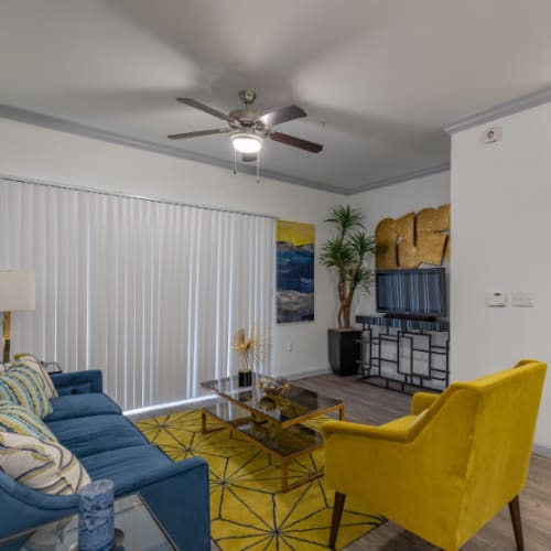 Modern living room with ceiling fan at Legacy at Cypress in Cypress, Texas